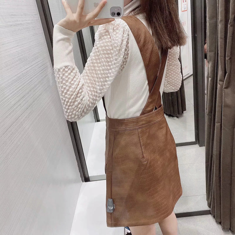 Faux leather mini skirt with strap