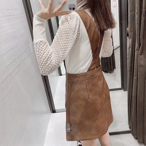 Faux leather mini skirt with strap