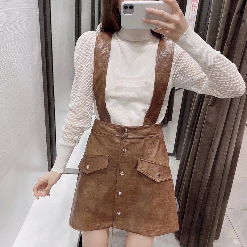 Faux leather mini skirt with strap