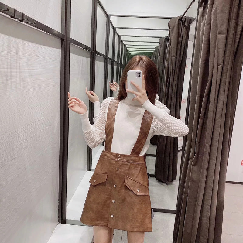 Faux leather mini skirt with strap