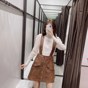 Faux leather mini skirt with strap